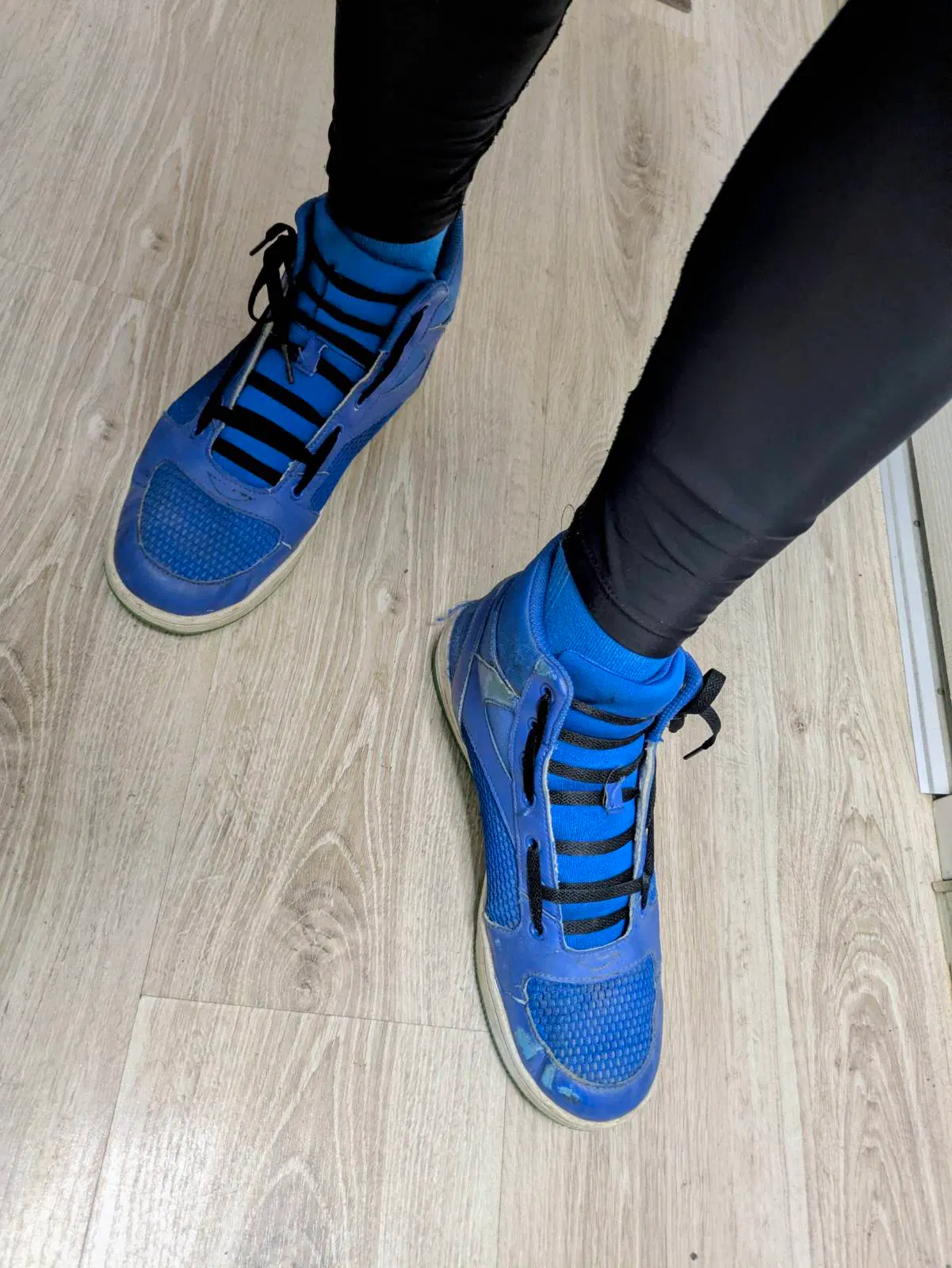 top-down view of poster's bright blue Chucks-style boots laced in the Biking Lace Pattern